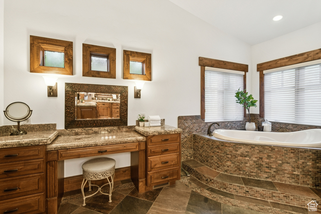 Bathroom with a bath, tile patterned floors, and recessed lighting