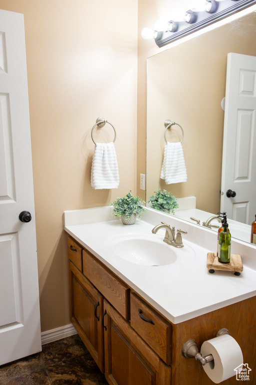 Bathroom with vanity and baseboards