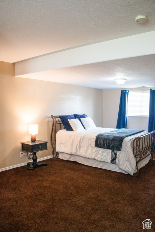 Bedroom with carpet floors and a textured ceiling