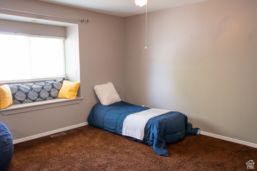 Carpeted bedroom featuring baseboards