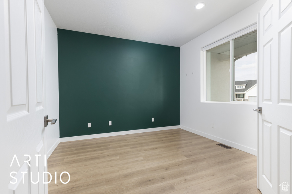 Spare room featuring light wood-type flooring and recessed lighting