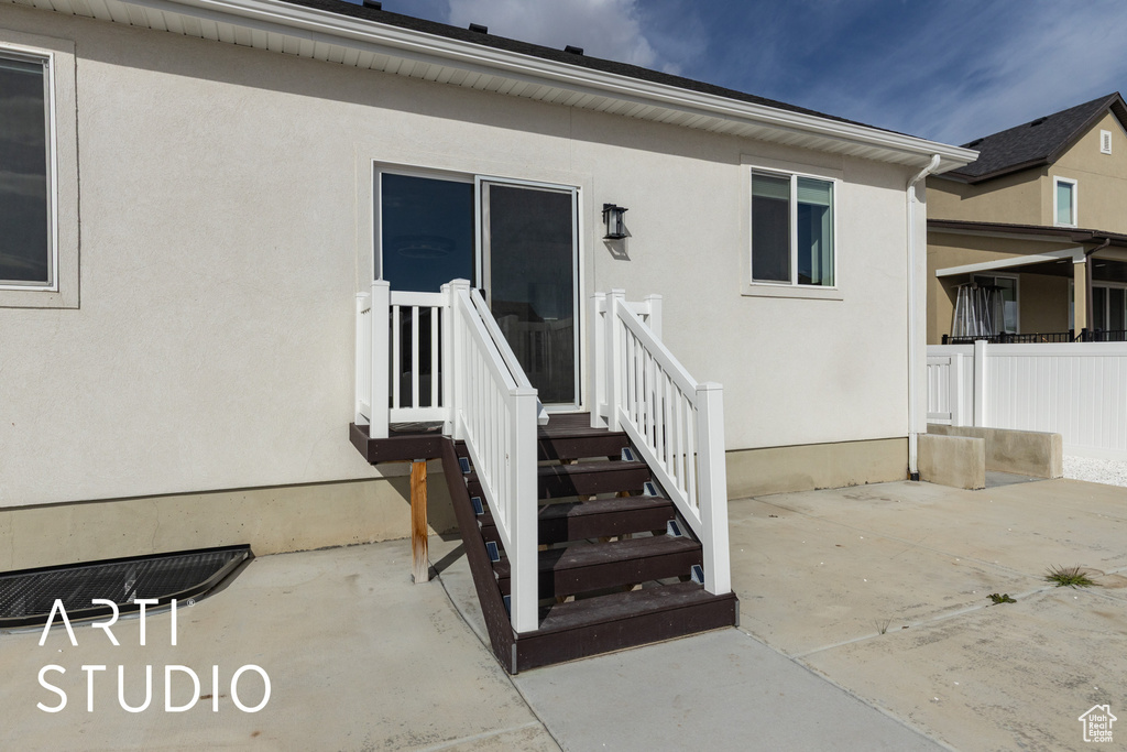 Doorway to property with stucco siding and a patio area