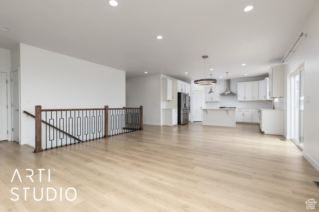 Unfurnished living room featuring light wood-style flooring and recessed lighting
