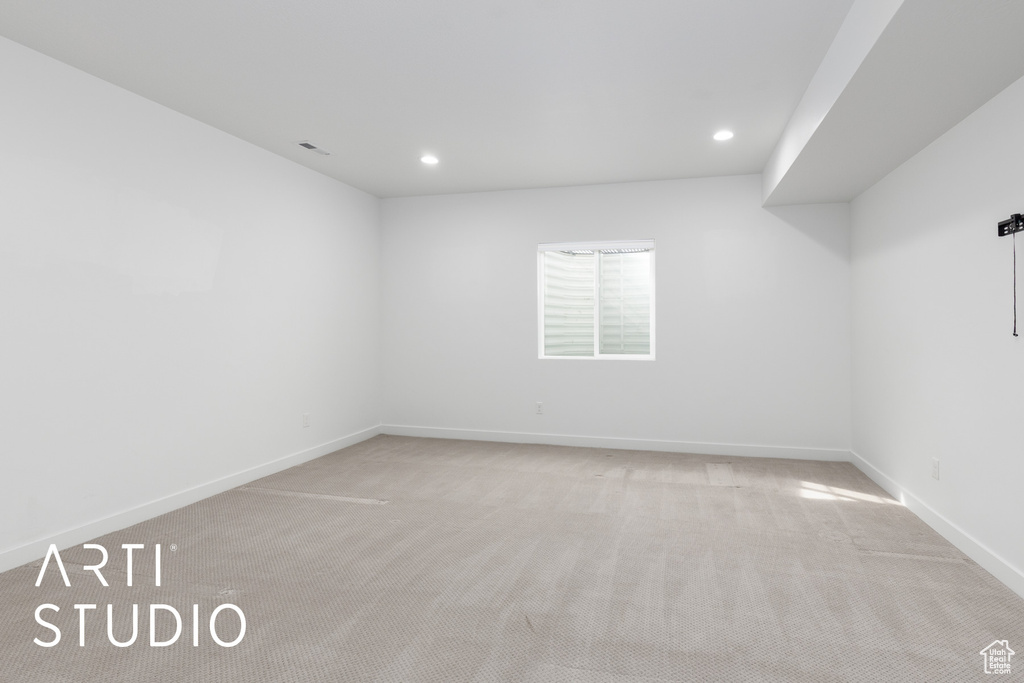 Carpeted empty room featuring baseboards and recessed lighting