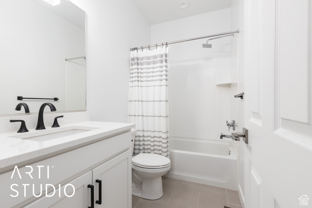 Bathroom featuring vanity, shower / bath combination with curtain, and tile patterned floors