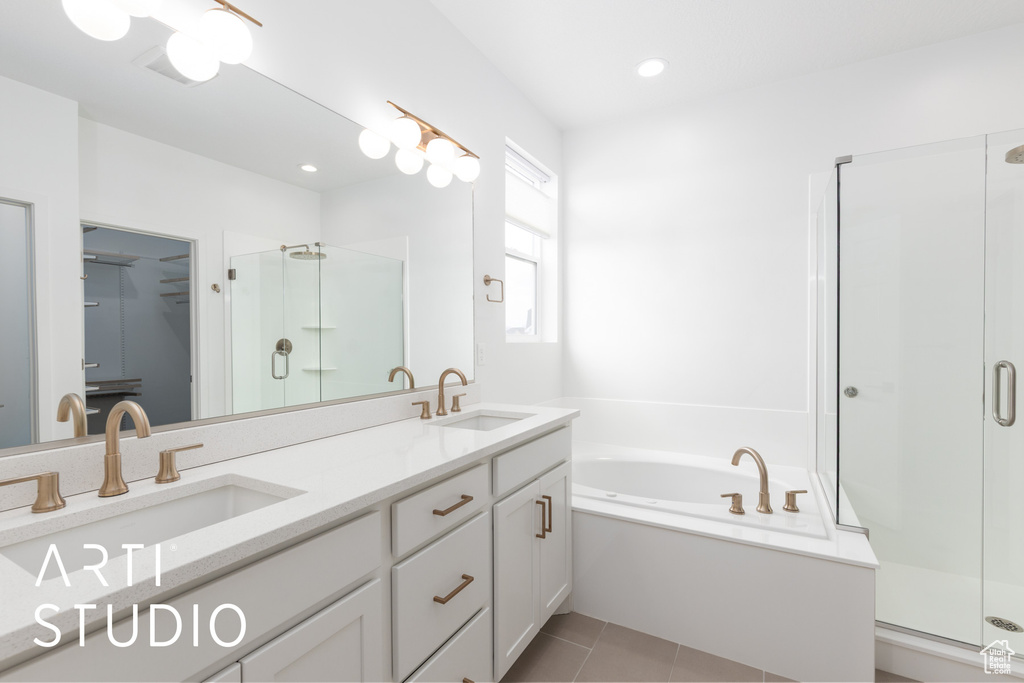 Full bathroom featuring a shower stall, double vanity, a bath, tile patterned floors, and a spacious closet