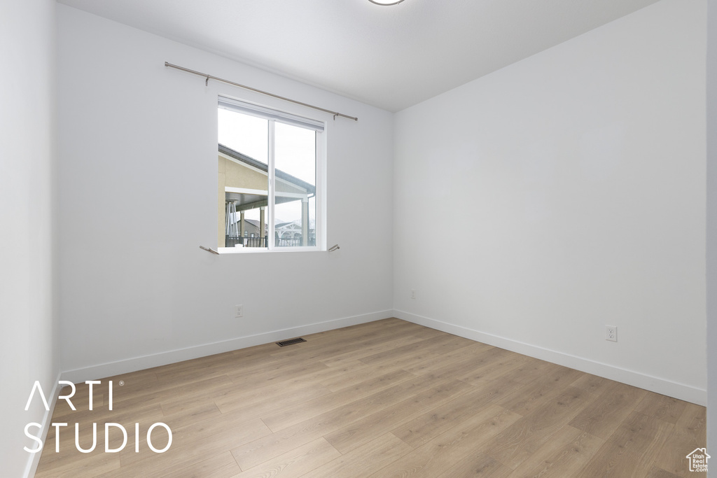Unfurnished room featuring baseboards and light wood-type flooring