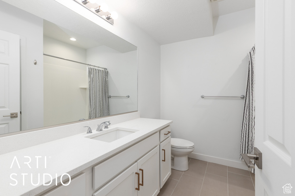 Full bath featuring vanity, tile patterned flooring, and curtained shower