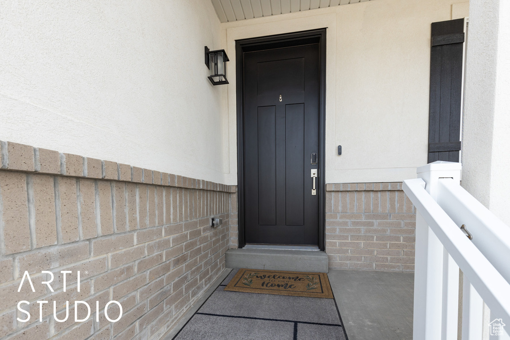 View of exterior entry featuring stucco siding