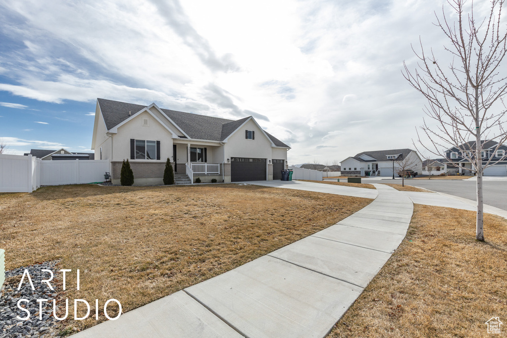View of front of home with stucco siding, concrete driveway, a garage, and roof with shingles
