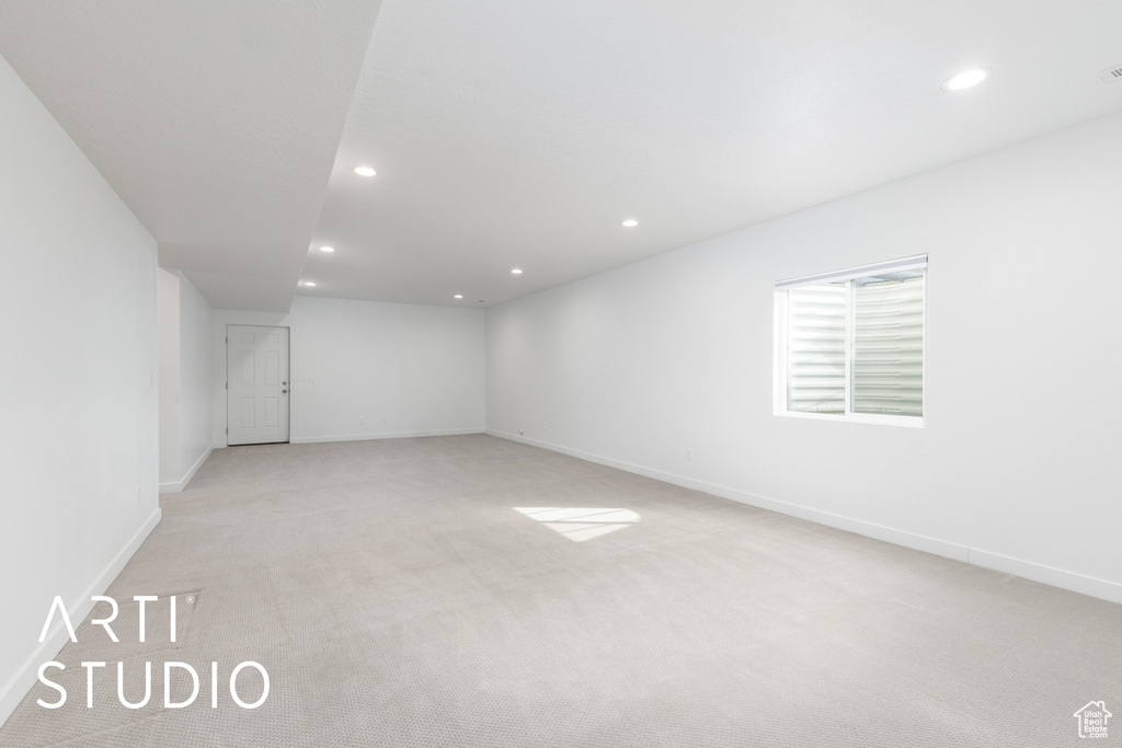 Spare room with light carpet and recessed lighting