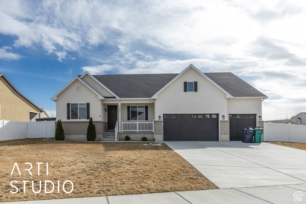 View of front facade with covered porch, stucco siding, concrete driveway, a shingled roof, and an attached garage