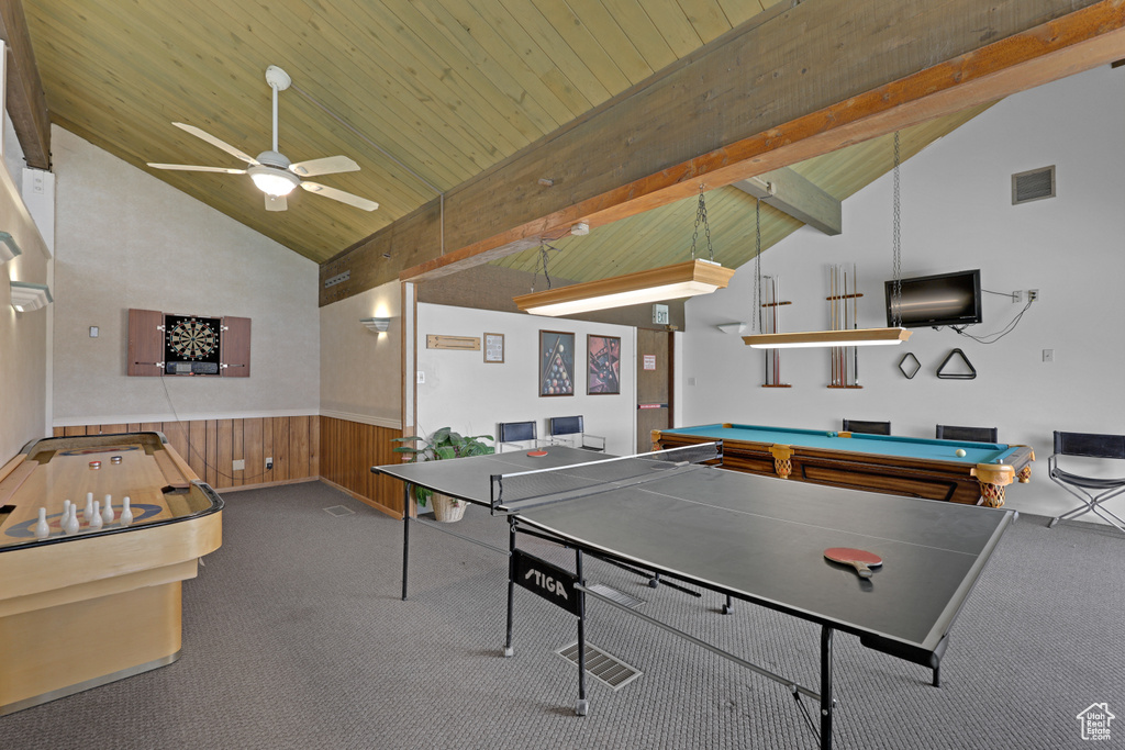 Rec room with pool table, carpet floors, a wainscoted wall, high vaulted ceiling, and ceiling fan