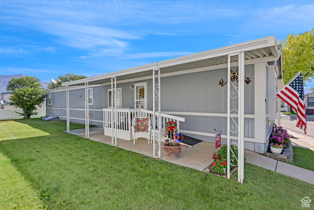 Back of property with a yard