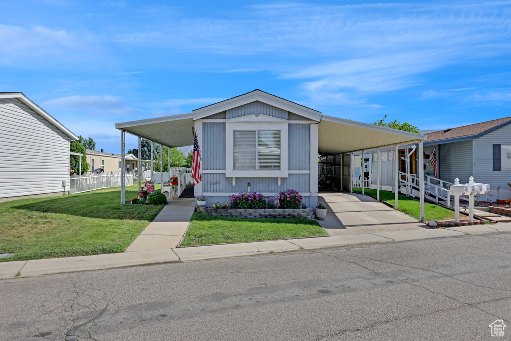 Manufactured / mobile home with a carport and driveway