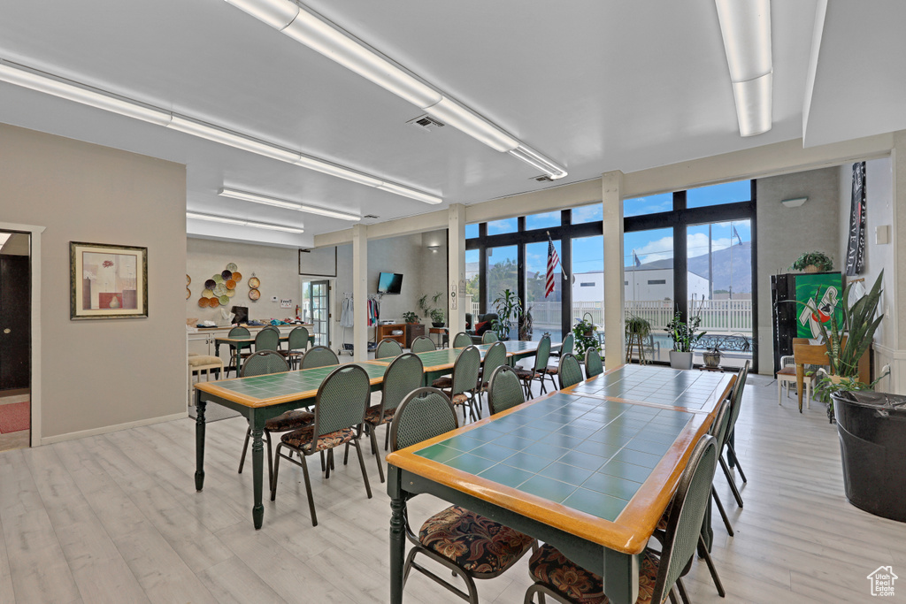 Dining room featuring light wood-style flooring and baseboards
