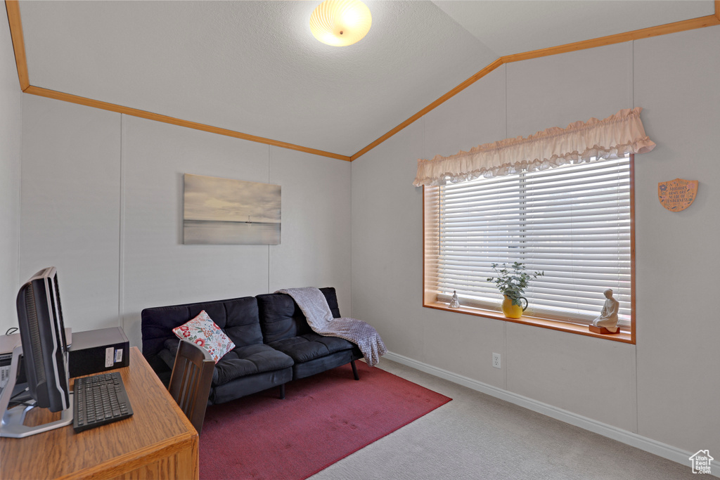Carpeted office space featuring vaulted ceiling and crown molding