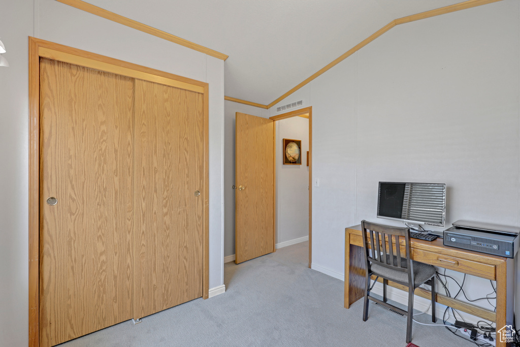 Office space featuring carpet flooring, lofted ceiling, and crown molding