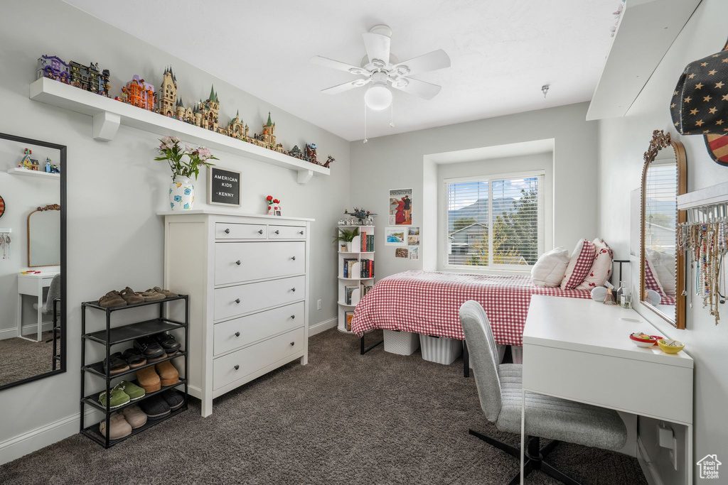 Bedroom featuring dark colored carpet and ceiling fan