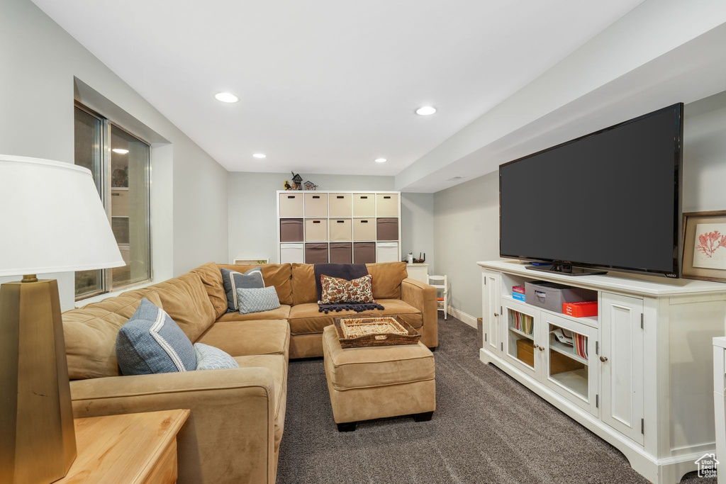 Living room with recessed lighting and dark colored carpet