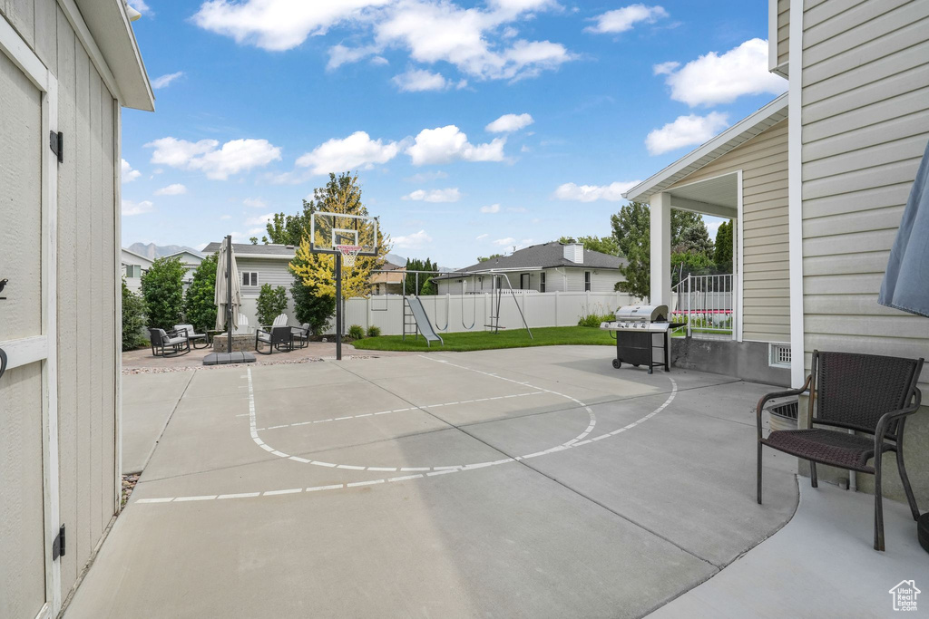View of basketball court featuring a residential view and basketball court