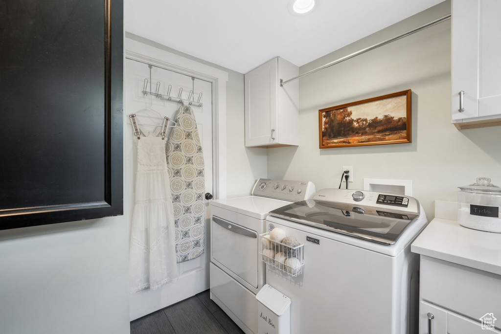 Washroom featuring separate washer and dryer and cabinet space