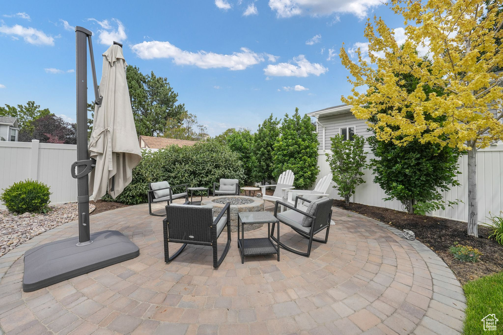 Fenced backyard with a patio area and an outdoor fire pit
