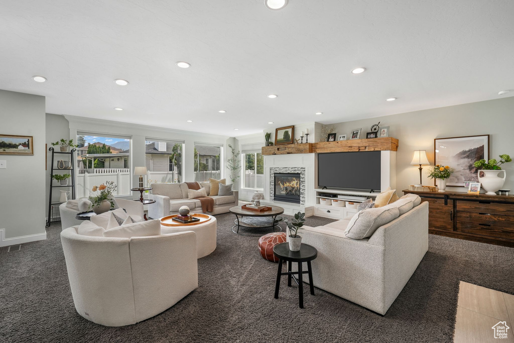 Carpeted living area featuring recessed lighting and a fireplace