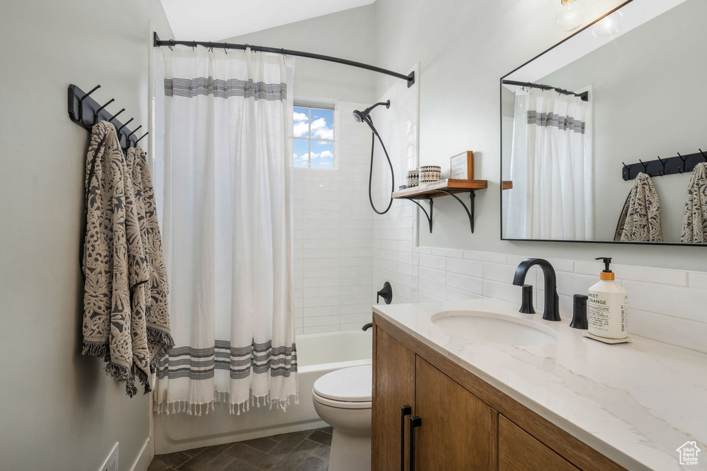 Bathroom with vanity and shower / bath combination with curtain