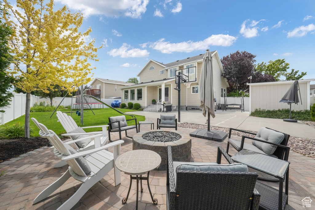 Patio / terrace with a patio area, an outdoor living space with a fire pit, and a fenced backyard