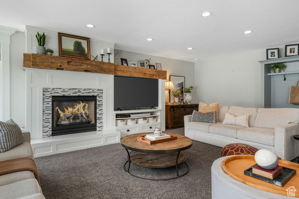 Carpeted living room featuring recessed lighting and a fireplace