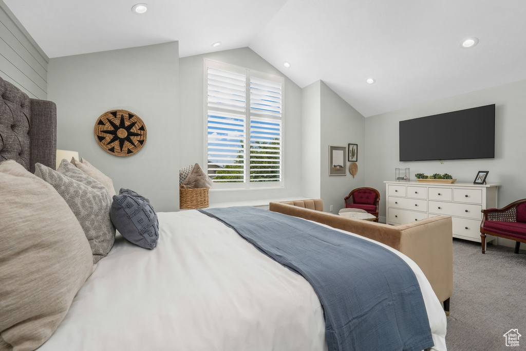Carpeted bedroom featuring vaulted ceiling and recessed lighting