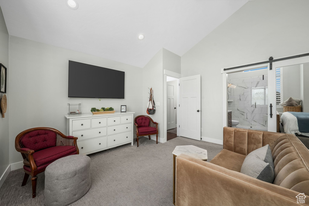 Living area with light colored carpet, lofted ceiling, and recessed lighting