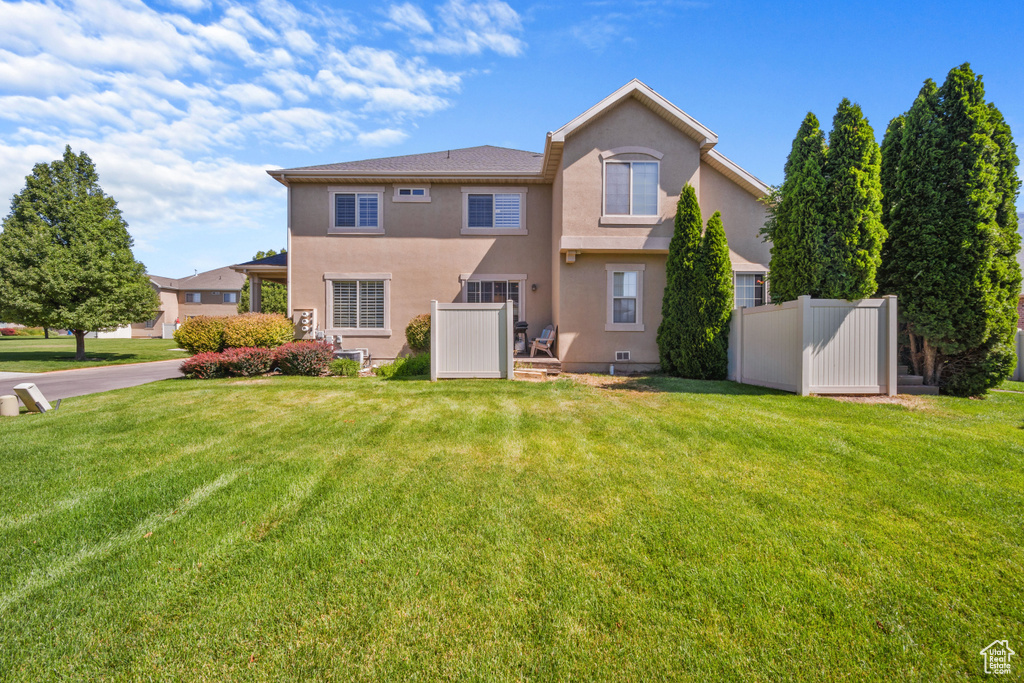 Back of property featuring stucco siding