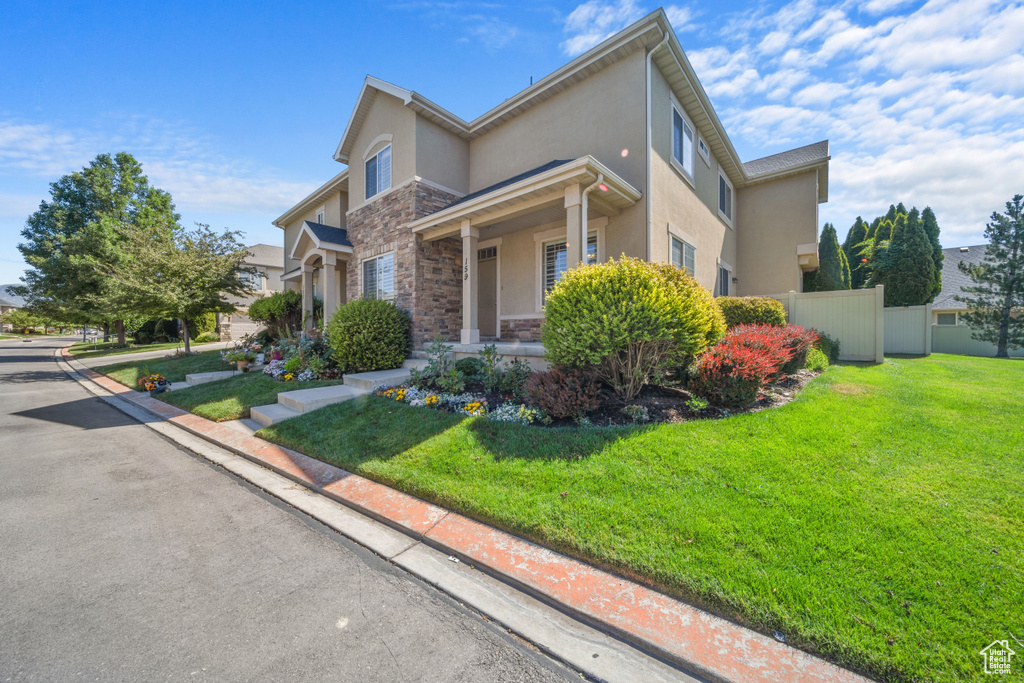 View of front of property with stone siding and stucco siding