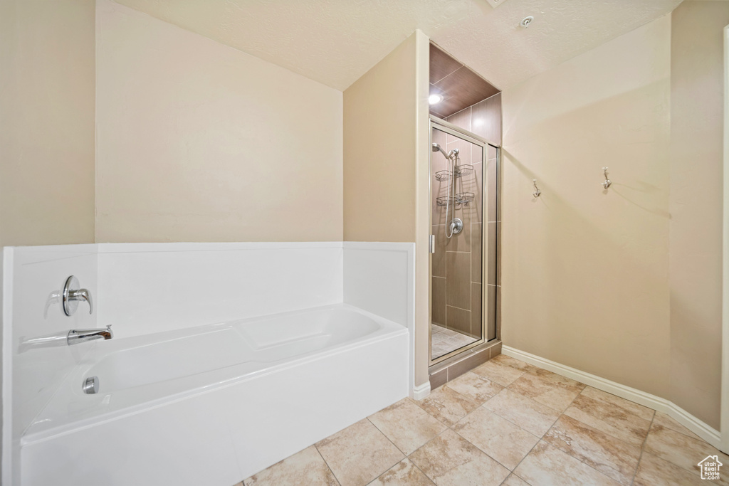 Full bathroom with a garden tub and a shower stall
