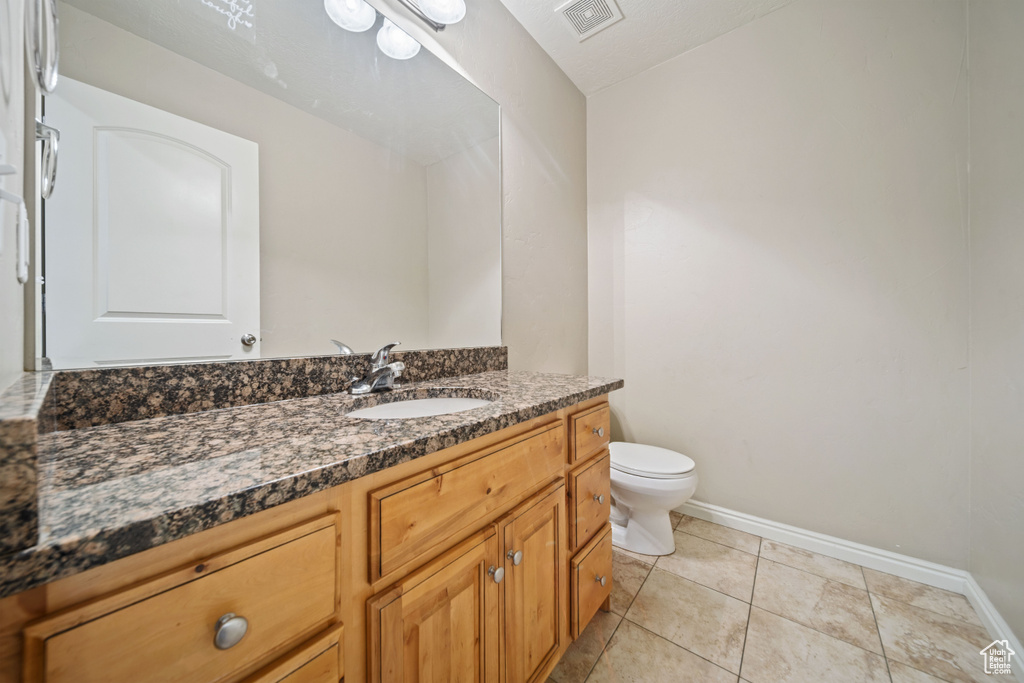 Bathroom featuring vanity and tile patterned flooring