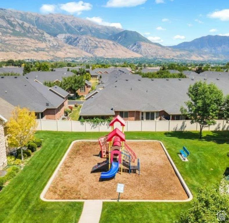 Community jungle gym with a mountain view and a residential view