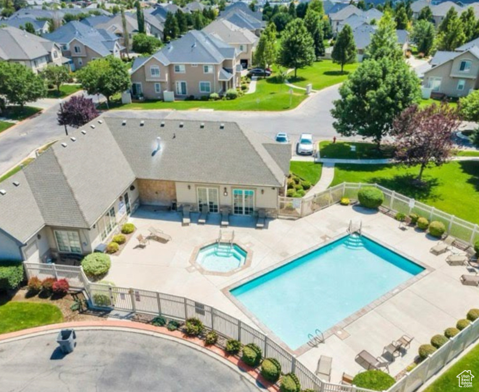 Aerial perspective of suburban area featuring a pool