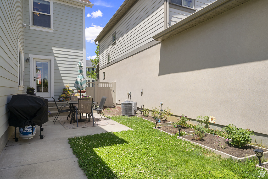 View of yard with a patio and a garden