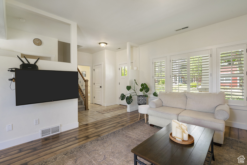 Living area featuring stairway and wood finished floors