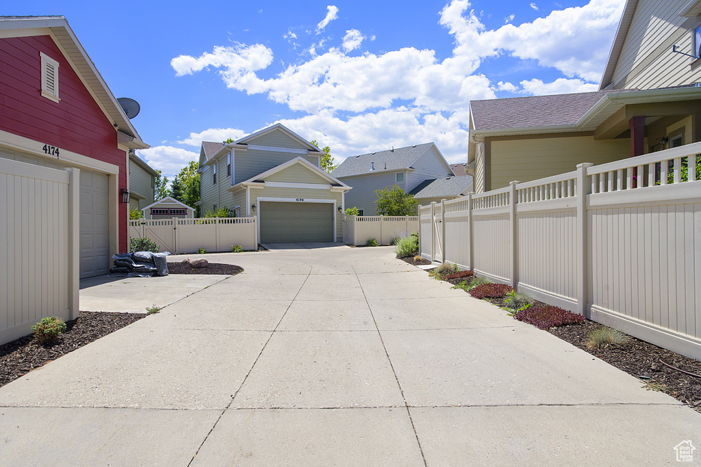View of yard with a garage, driveway, and a residential view