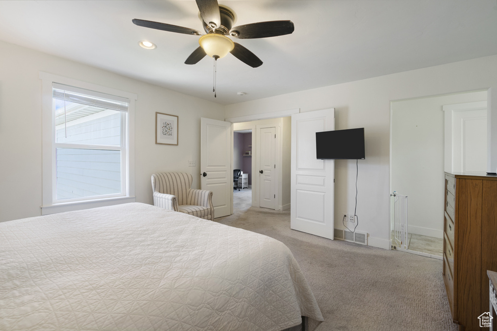 Bedroom featuring light colored carpet and a ceiling fan