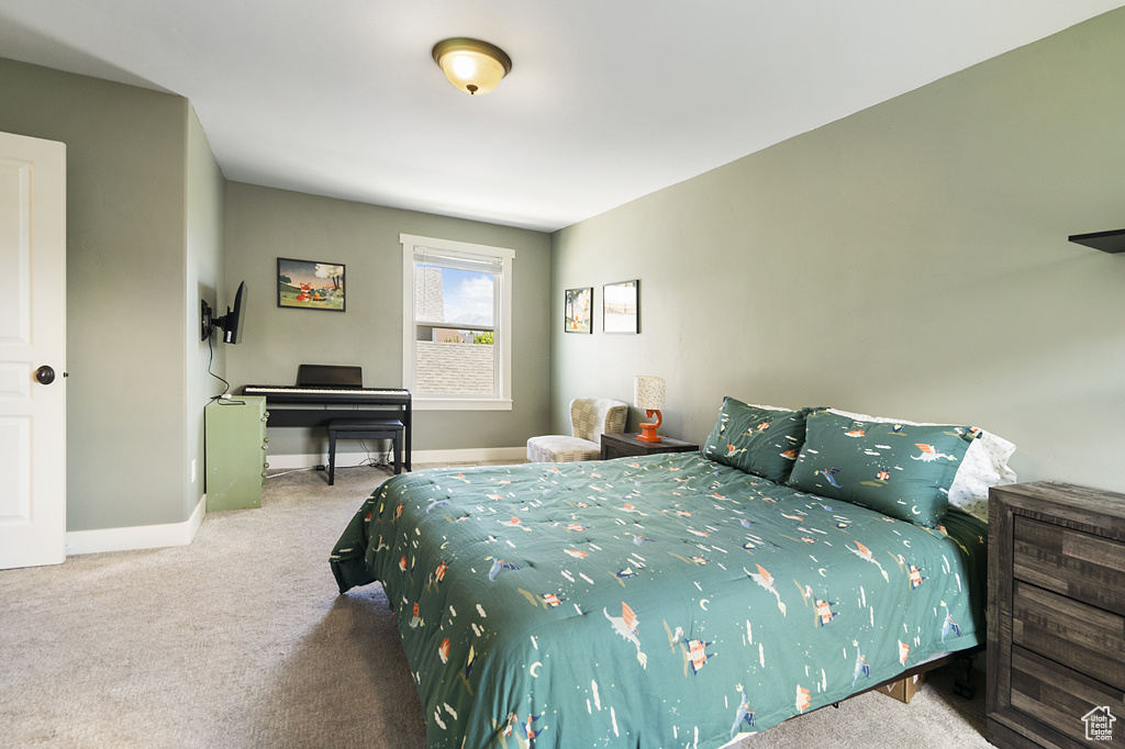 Carpeted bedroom featuring baseboards