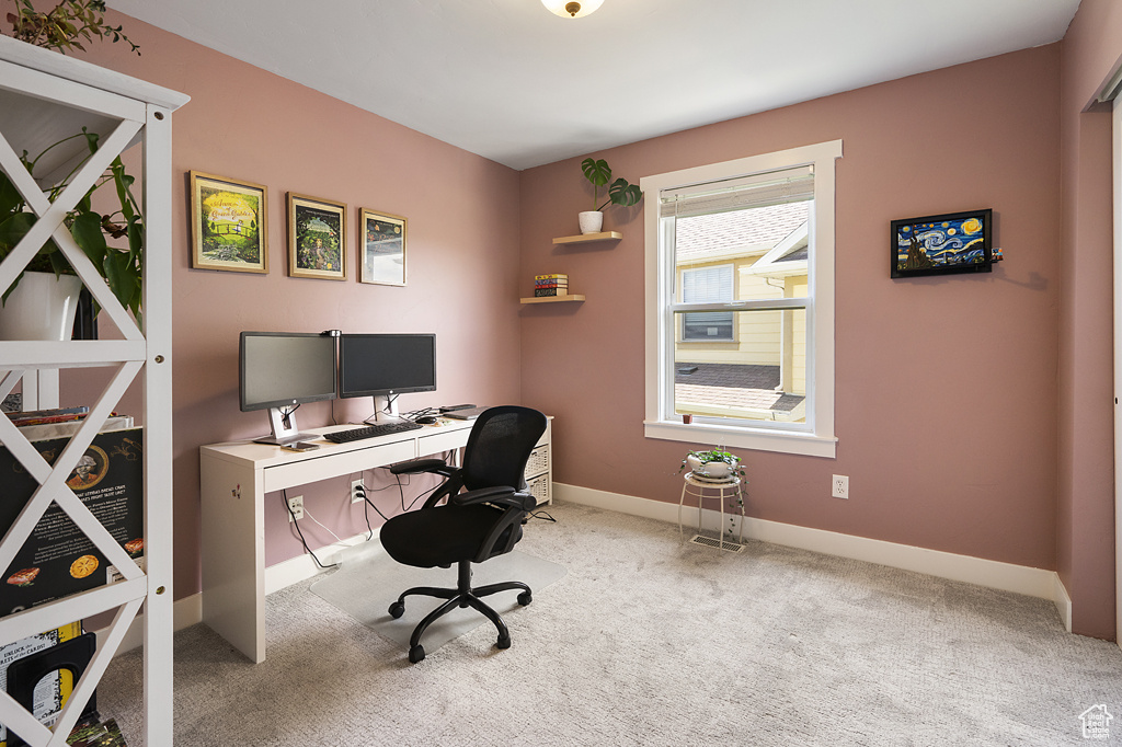 Carpeted office featuring baseboards