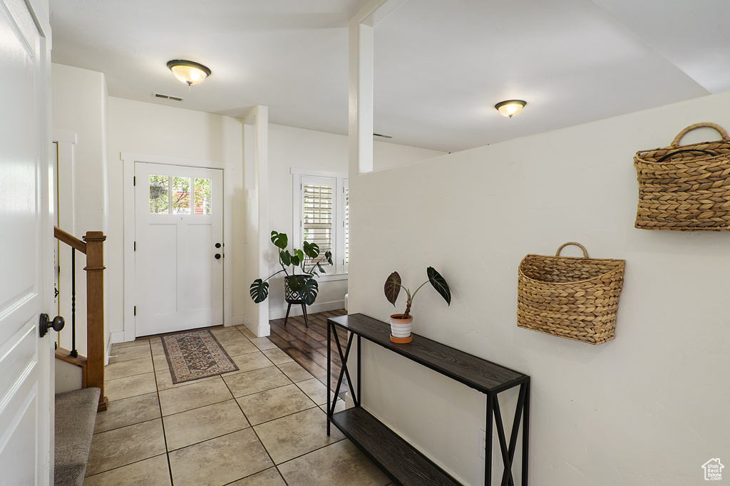 Foyer entrance featuring light tile patterned floors