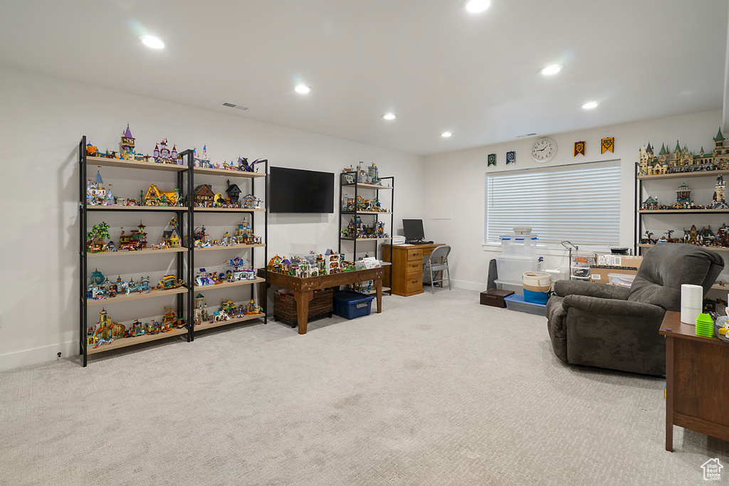 Living area with carpet flooring and recessed lighting