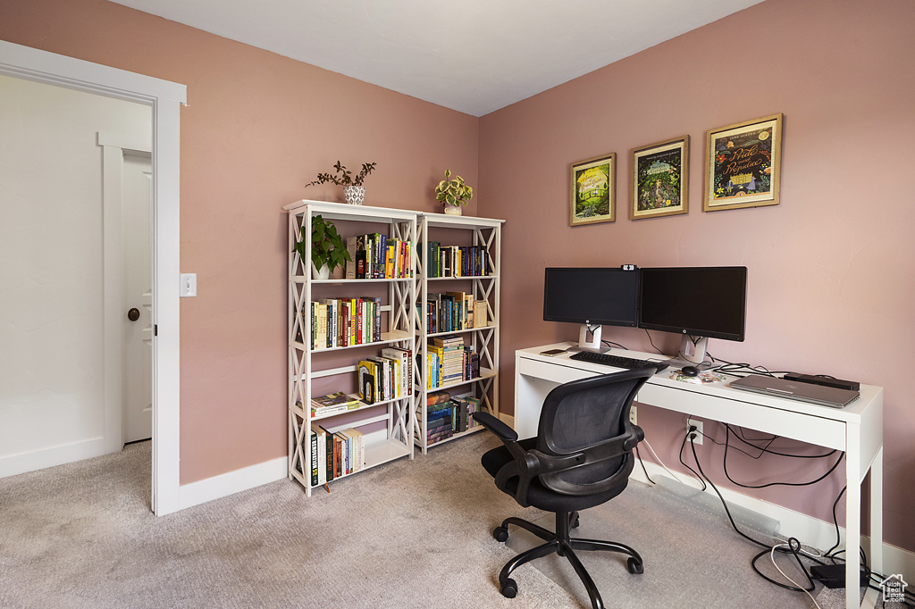 Carpeted office space featuring baseboards
