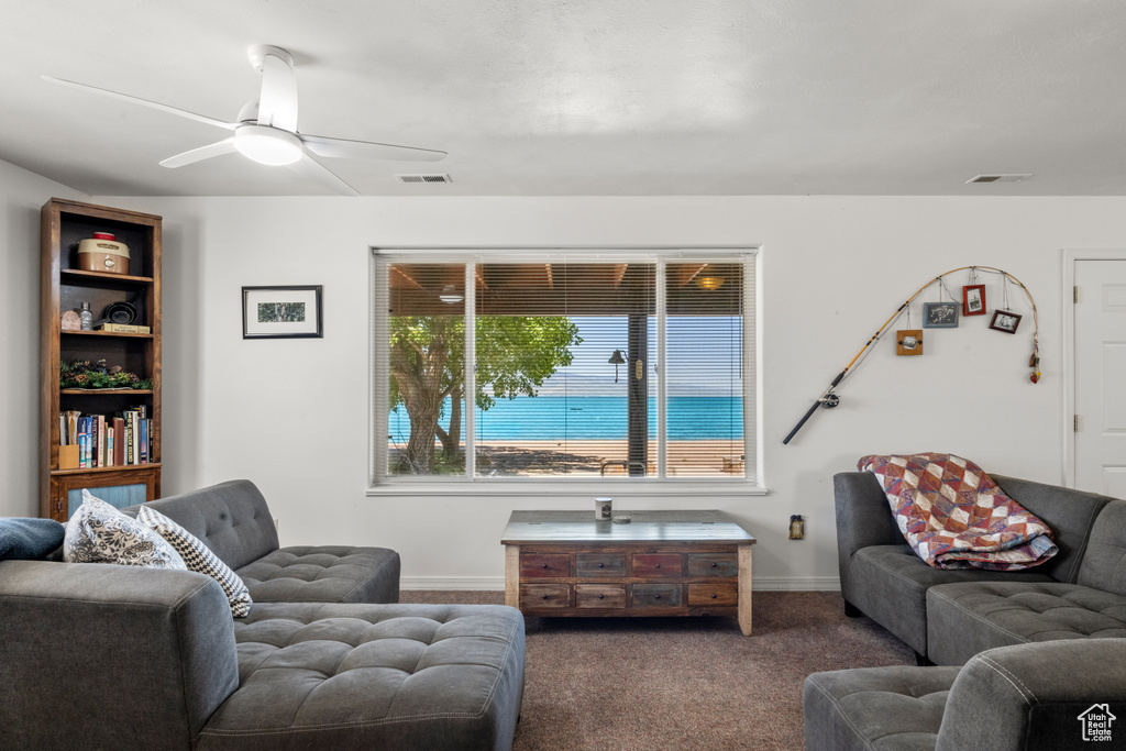 Living room with carpet floors and ceiling fan