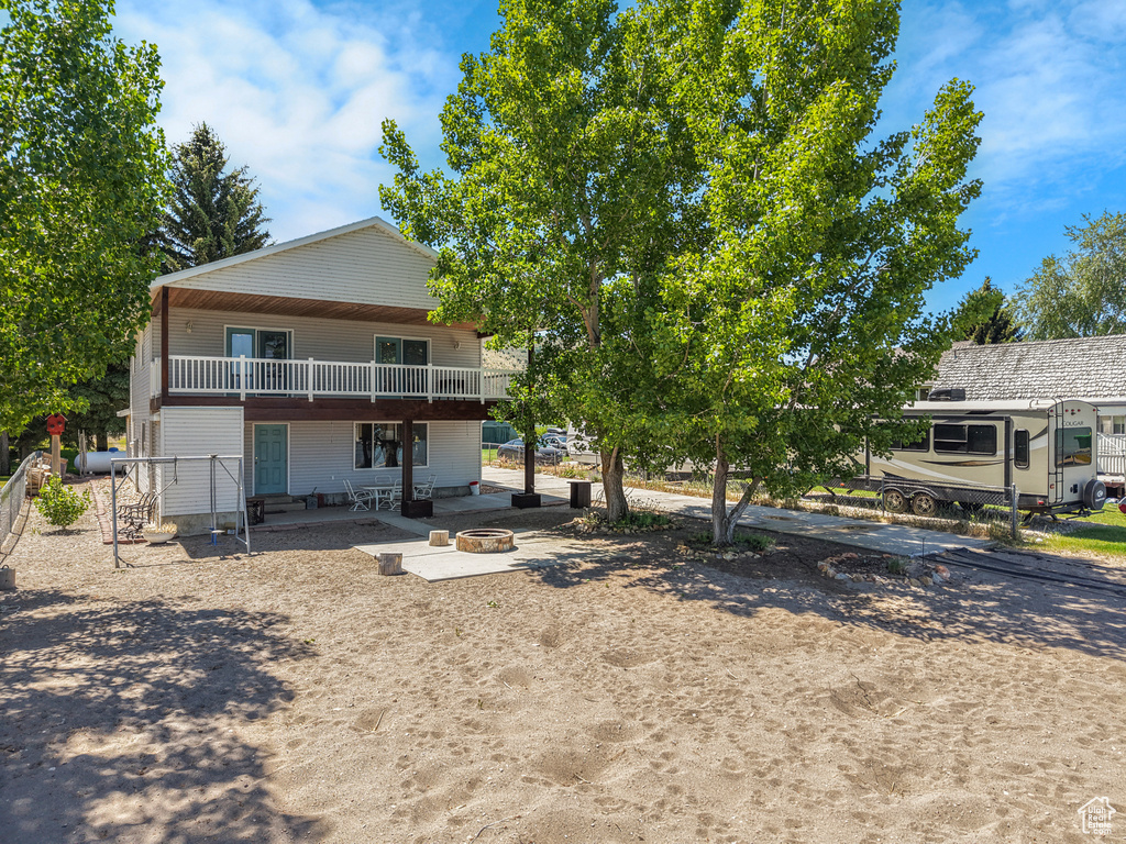 Back of house with an outdoor fire pit and a patio area